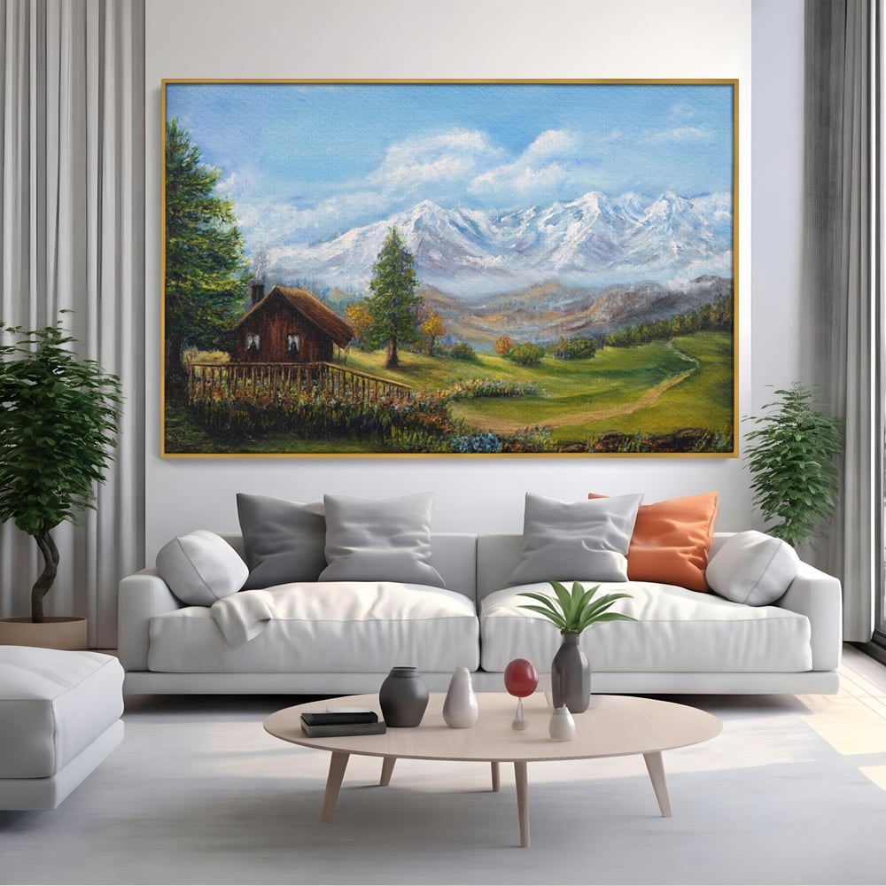 Tablou canvas cu tablou canvas cu peisaj montan si cabana, in rama de aluminiu auriu, pe perete intr-un living